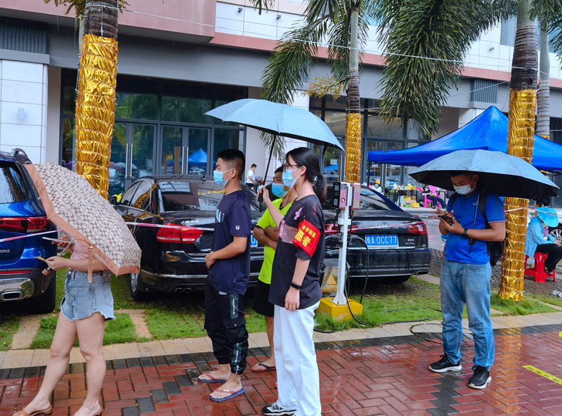 志愿者為市民擋雨。共青團龍華區委供圖